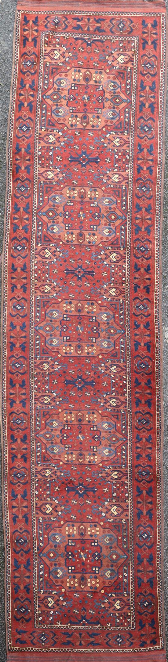 An Ersari red ground runner, 13ft by 3ft 6in.